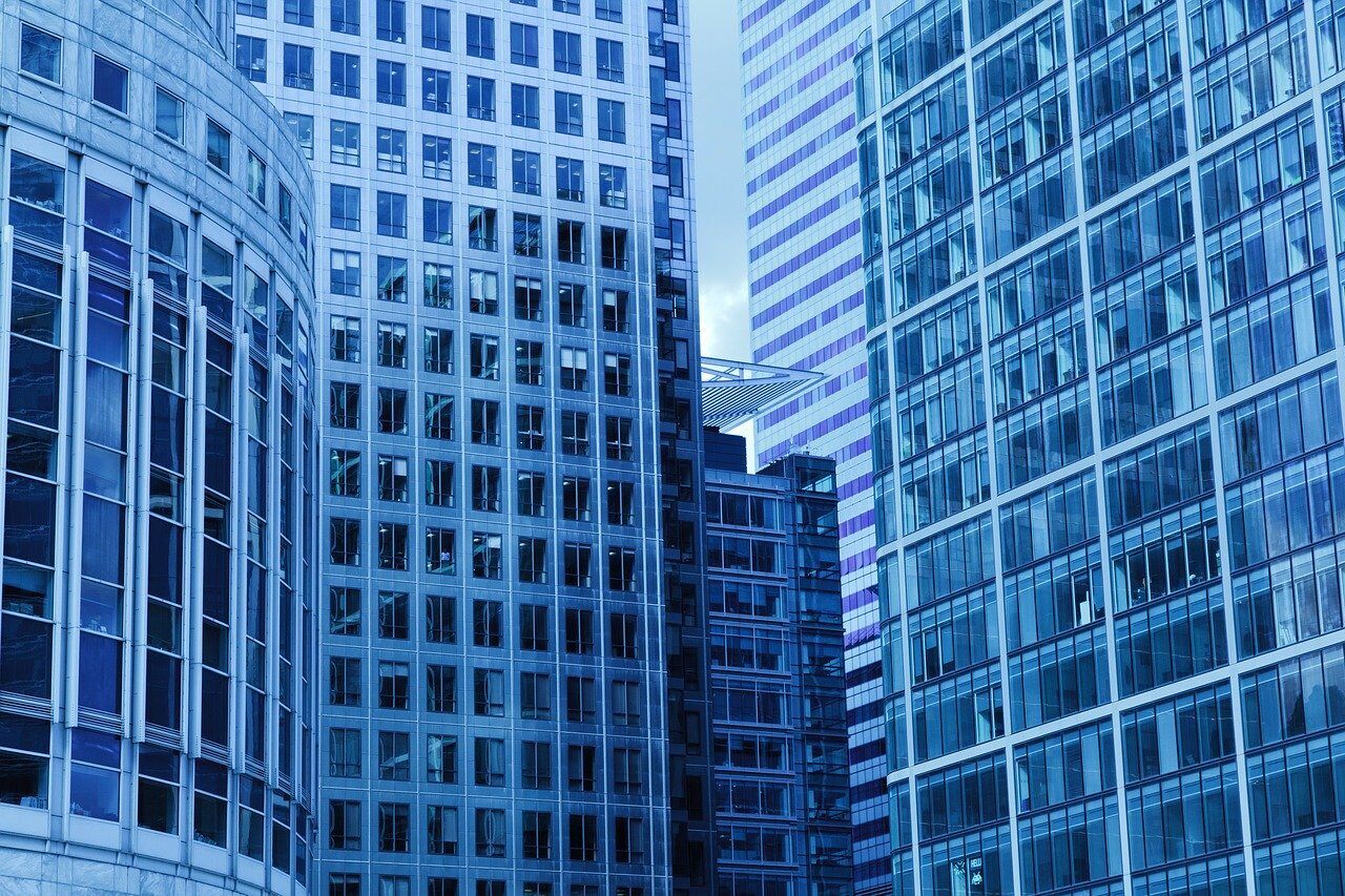Blue glass office towers viewed from street level